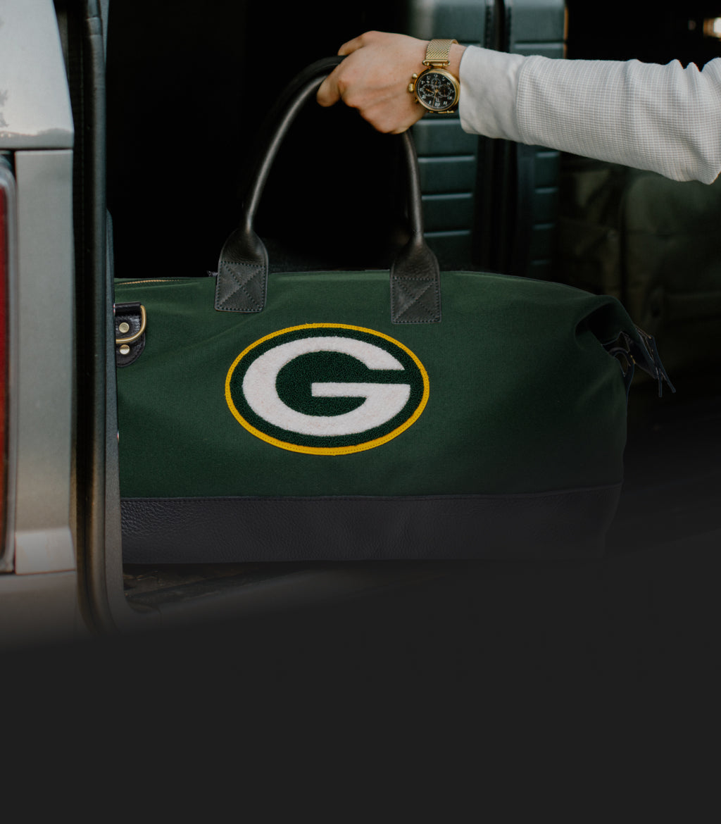 Green Bay packers weekender bag unloaded from a tailgate.